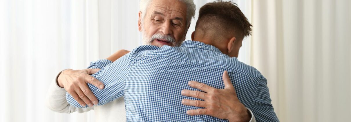 Father and son in an embrace as a representation of a healthy father-son relationship