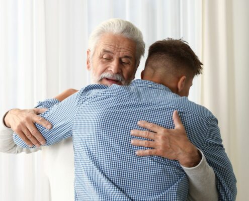 Father and son in an embrace as a representation of a healthy father-son relationship