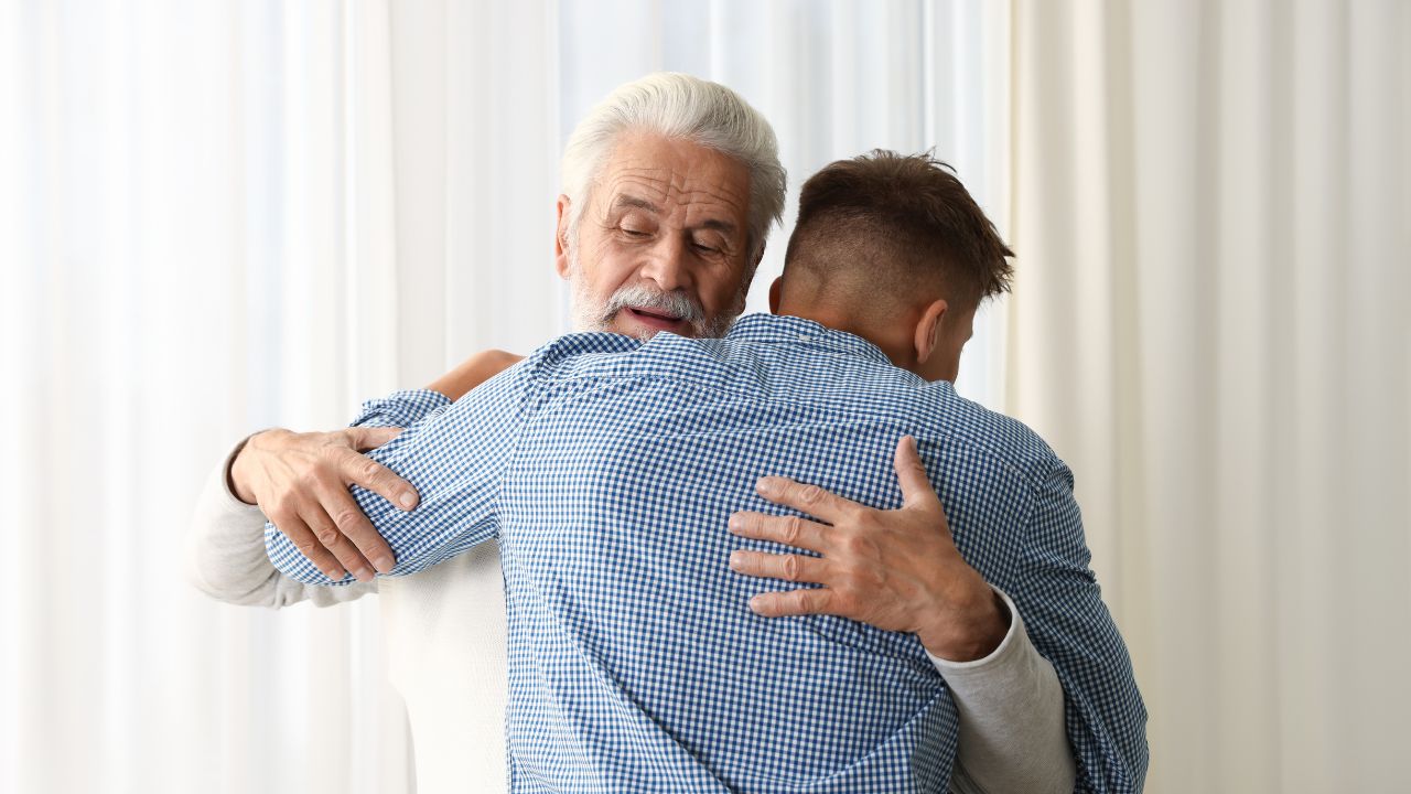 Father and son in an embrace as a representation of a healthy father-son relationship